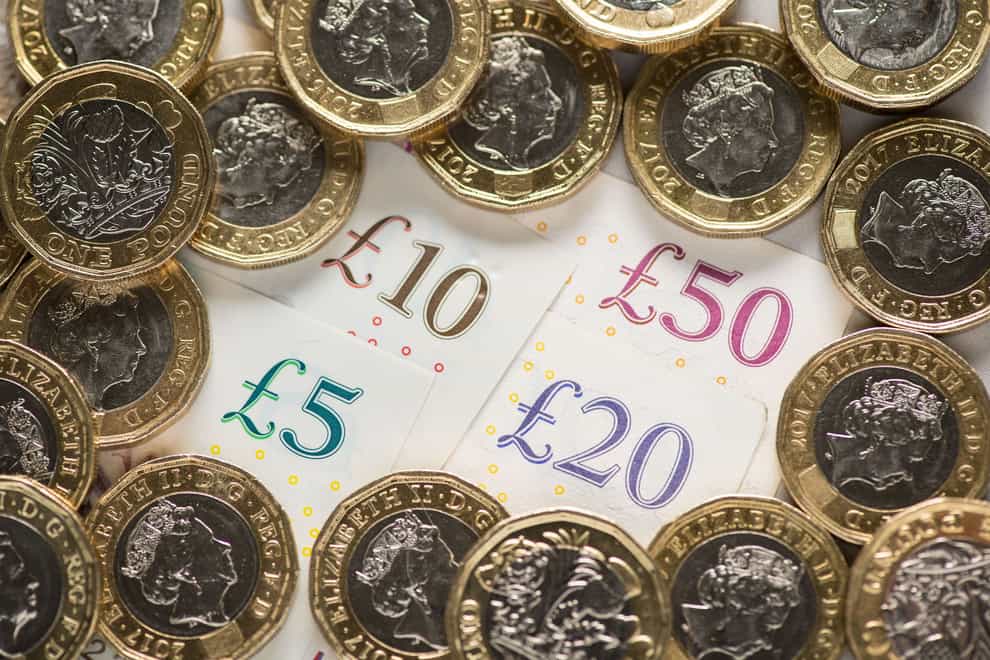 Pay growth has eased back at the fastest pace for two years, while vacancies dropped further in the longest run of declines on record, according to official figures (PA)