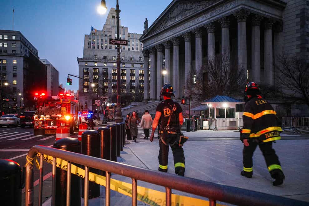 New York firefighters walk up to the entrance of New York Supreme Court (Robert Bumsted/AP)