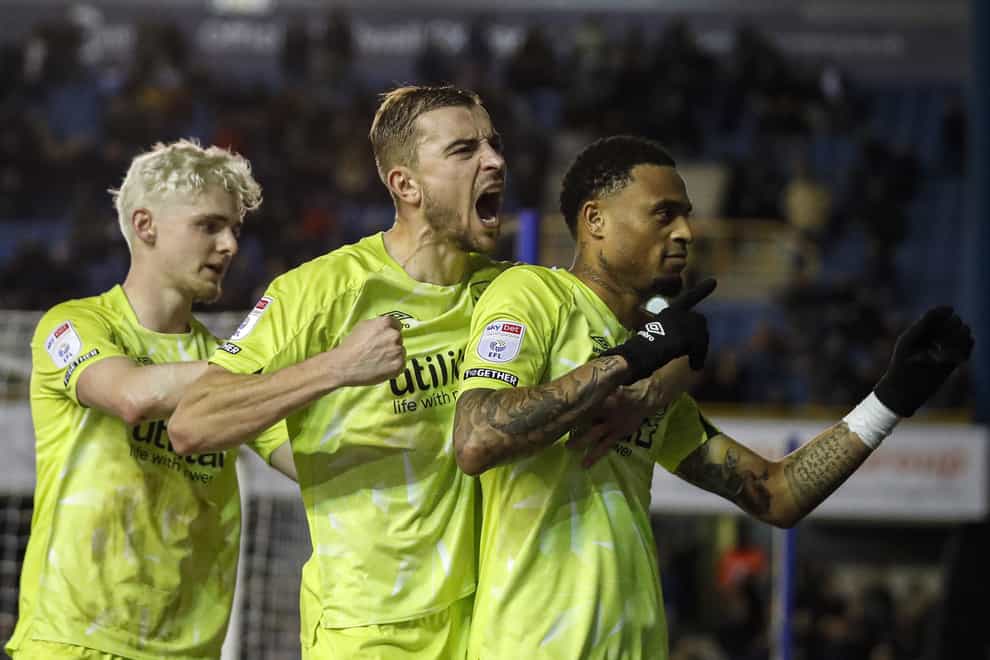 Delano Burgzorg celebrates after scoring Huddersfield’s equaliser at Millwall (Ben Whitley/PA)
