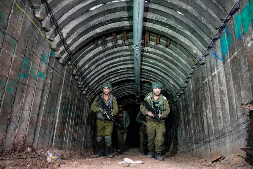 Israeli soldiers are seen in a tunnel that the military says Hamas militants used to attack the Erez crossing (Ariel Schalit/AP)