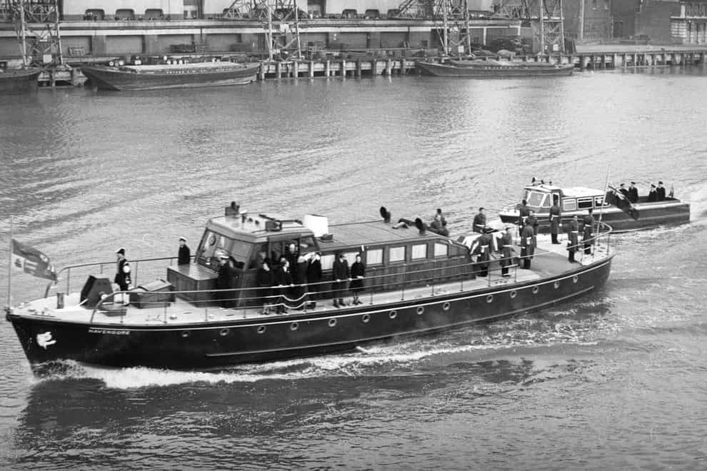 The Havengore, bearing the body of Sir Winston Churchill, travelling along the Thames to Festival Pier (PA)
