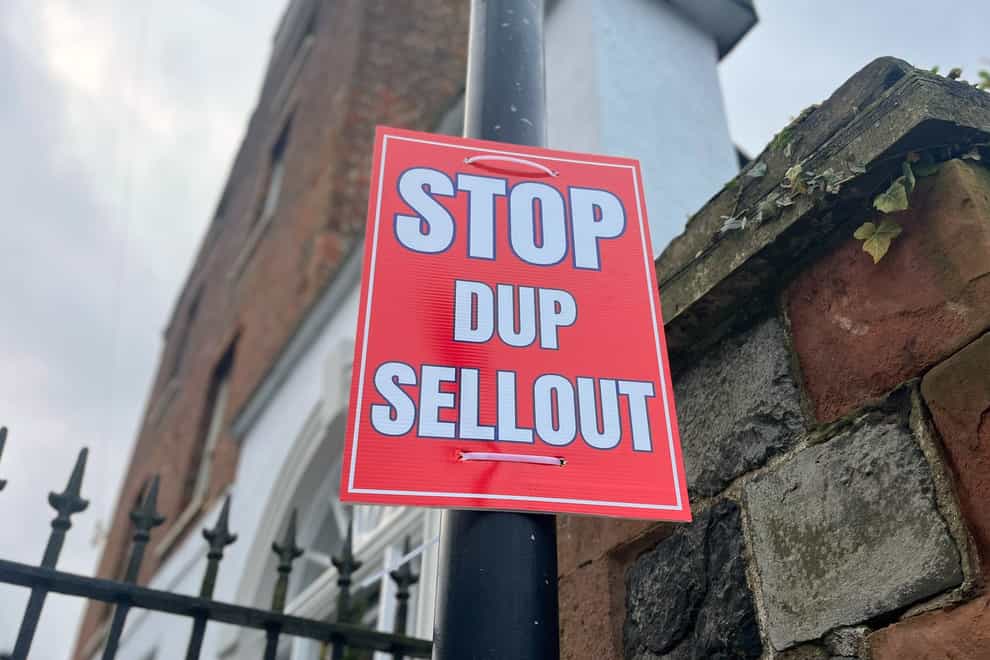 A poster stating ‘Stop DUP sellout’ on a lamp post near Hillsborough Castle, where representatives from the Northern Ireland political parties are meeting for further talks with the Government on a financial package for the region (PA)
