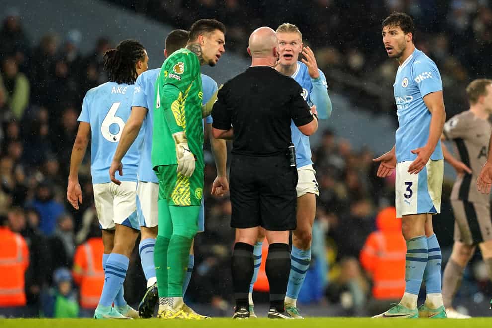 Manchester City players surround referee Simon Hooper during the 94th-minute of their 3-3 draw with Tottenham (Martin Rickett/PA)