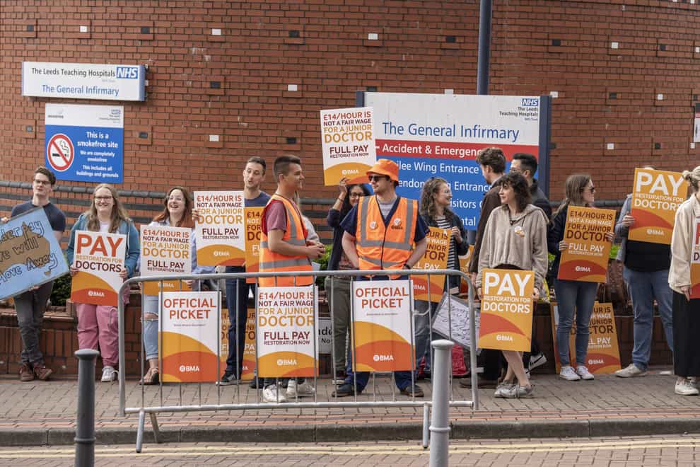Junior doctor and members of the British Medical Association on the picket line outside Leeds General Infirmary in July (Danny Lawson/PA)