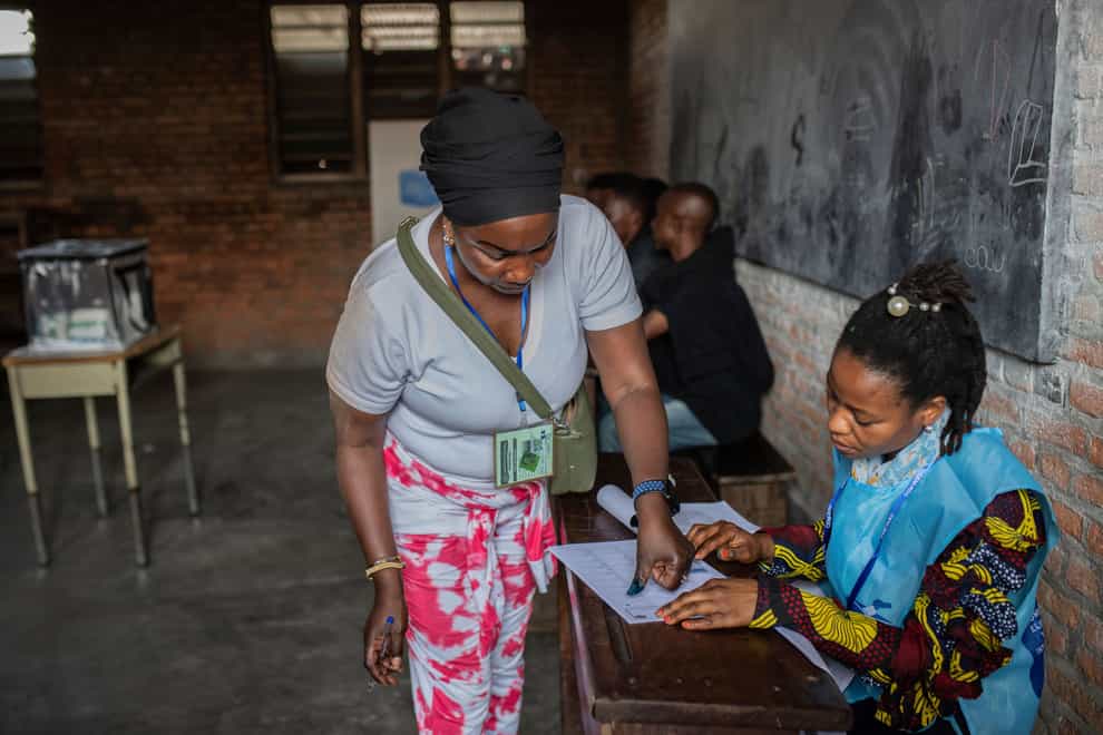 A woman goes through the voting process at a polling station in Goma, eastern Democratic Republic of Congo (AP)