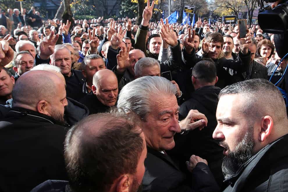 Sali Berisha, 79, the main leader of the center-right Democratic Party, centre, joins hundreds of protesters outside the Parliament building on Monday (Armando Babani/AP)