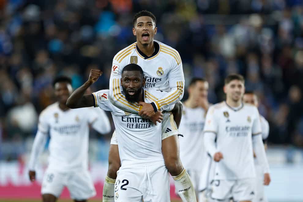 Real Madrid’s Antonio Rudiger, centre, and Jude Bellingham celebrate their victory at Alaves (Ricardo Larreina/AP)