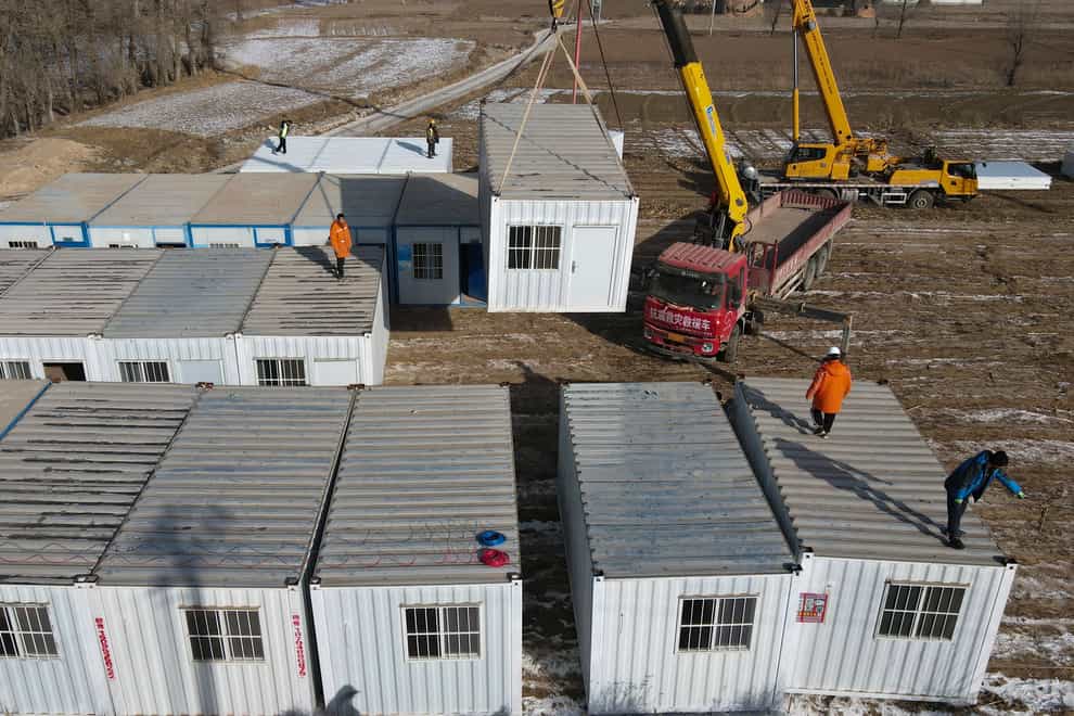 Moveable plank houses for earthquake victims are set up in Meipo Village, Jishishan County in northwest China’s Gansu Province (Fan Peishen/Xinhua via AP)