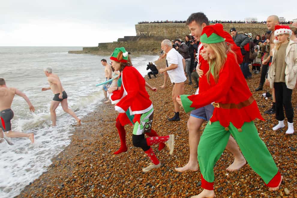 Swimmers heading into the sea at a Christmas Day dip in Brighton last year (Chris Ison/PA Images)