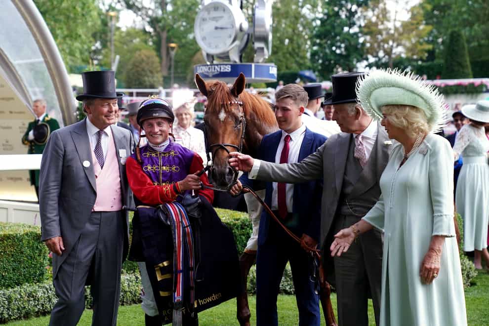 William Haggas with jockey Tom Marquand and the King and Queen after Desert Hero’s win at Royal Ascot (John Walton/PA)
