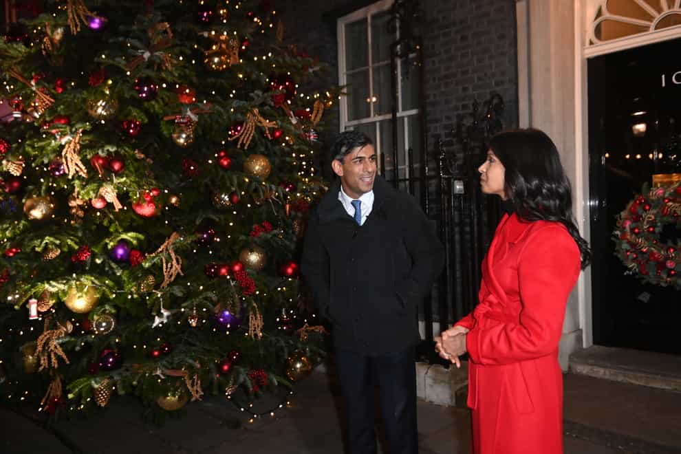 Prime Minister Rishi Sunak and his wife Akshata Murty at the switching on of the Downing Street Christmas tree lights (Eddie Mulholland/Daily Telegraph/PA)