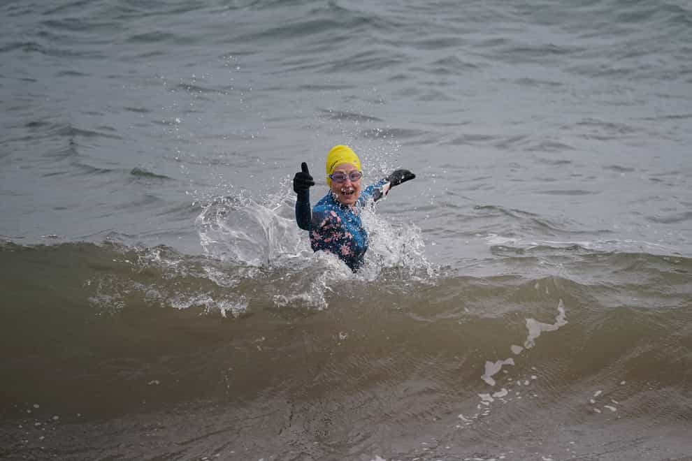 A swimmer in the sea in Dawlish Warren, south Devon on Christmas Eve (Yui Mok/PA)