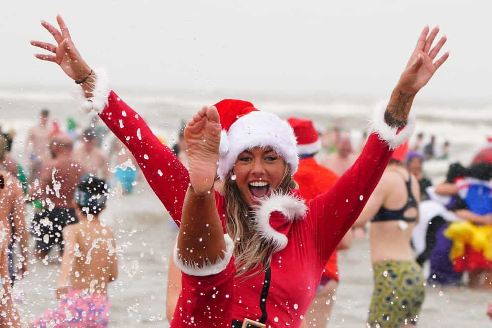 Keen swimmers saw in the Christmas celebrations with a dip in in Porthcawl, Wales (Ben Birchall/PA)