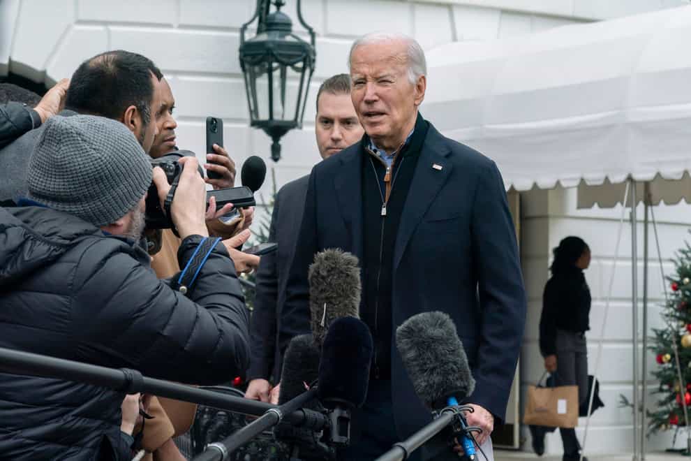 President Joe Biden speaks to members of the media as he leaves the White House to spend the Christmas holiday with his family at Camp David (AP)