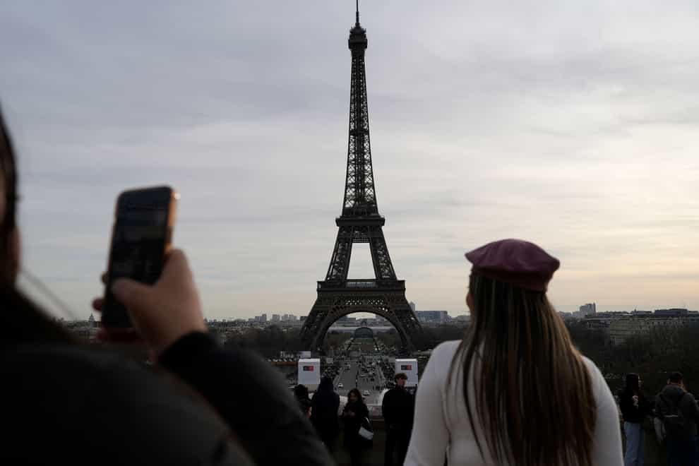 Tourists at the Eiffel Tower in Paris (Lewis Joly/AP)