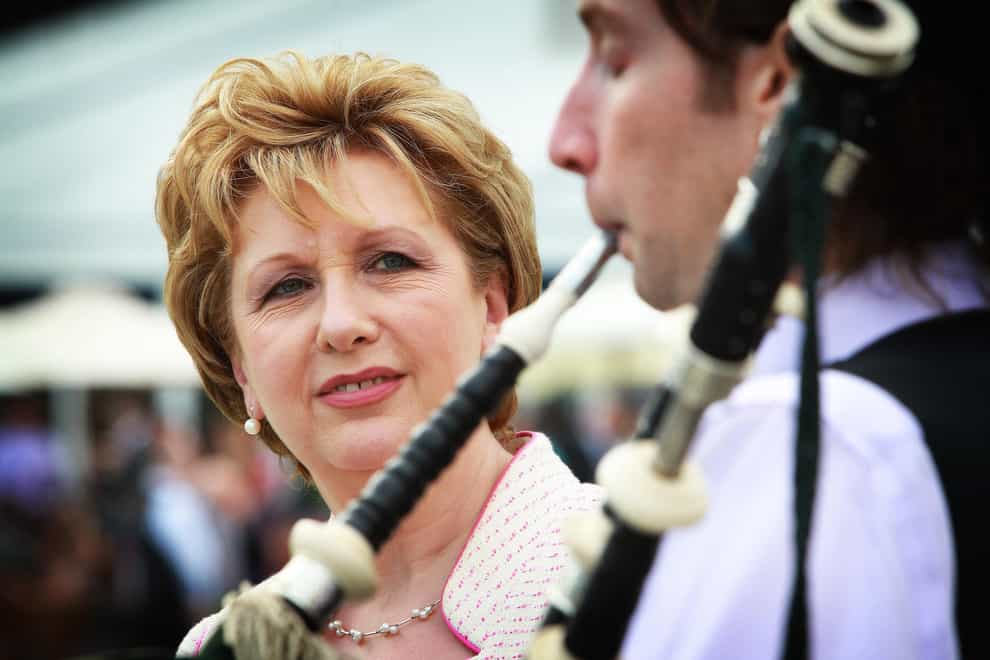 Then-Irish president Mary McAleese listens to a piper play in the grounds of Aras an Uachtarain (PA)