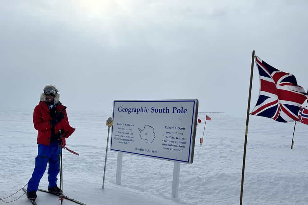 Harpreet Chandi, from Derby, posing beside the signpost at the end of her solo unsupported South Pole ski expedition (Harpreet Chandi/PA)