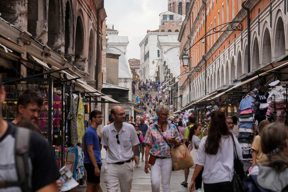 The streets of Venice are crowded with tourists during the summer months (AP Photo/Luca Bruno)