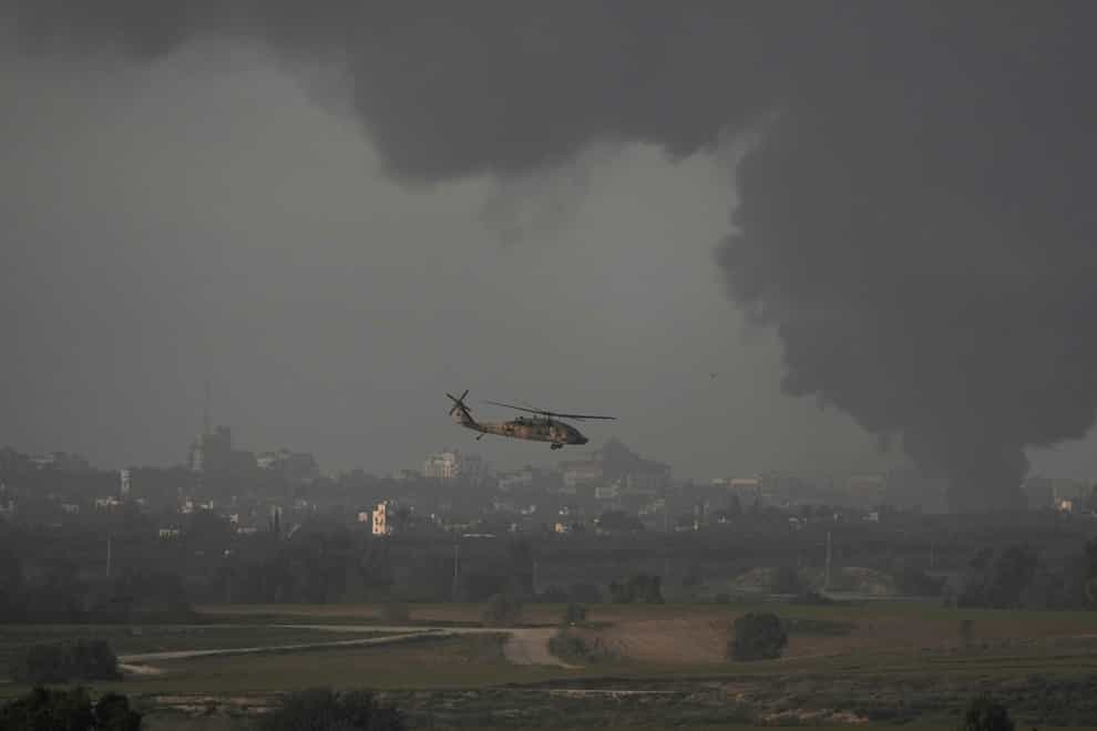 An Israeli military helicopter flies near the Israeli-Gaza border (Leo Correa/AP)