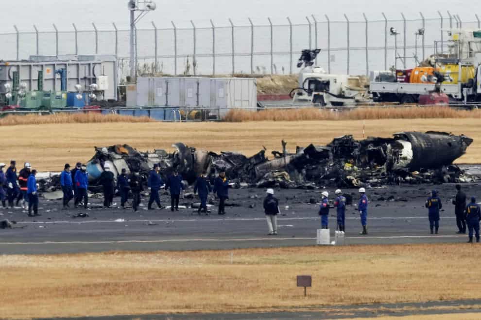 Transport officials and police have begun on-site investigations at Tokyo’s Haneda Airport after a large passenger plane and a Japanese coast guard aircraft collided on the runway and burst into flame (Kyodo News/AP)