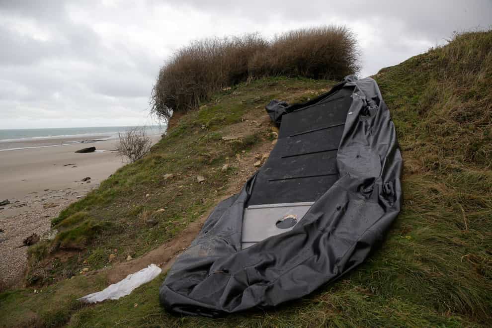 A damaged inflatable small boat on the shore in Wimereux, northern France (Michel Spingler/AP)