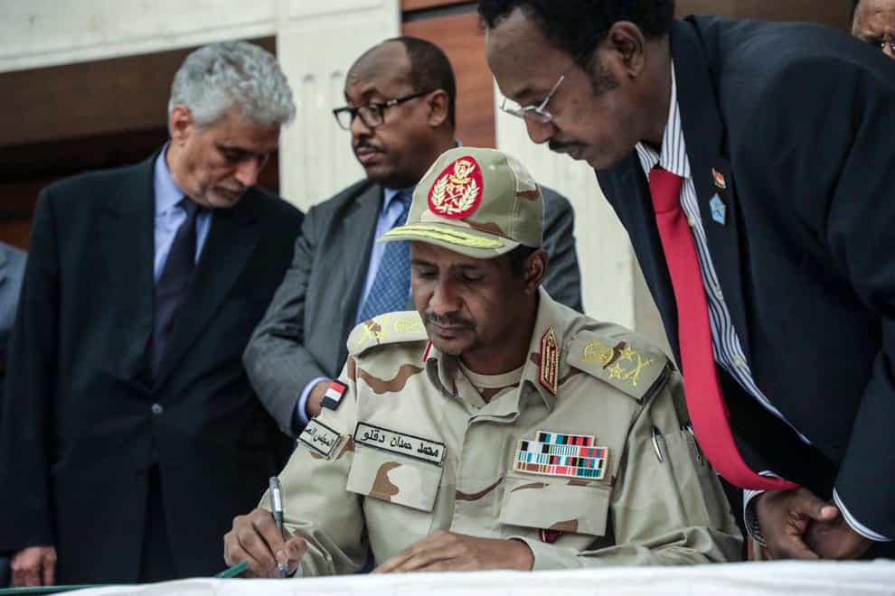 General Mohammed Hamdan Dagalo signs a power sharing document with Sudan’s pro-democracy movement and the ruling military council in Khartoum in 2019. (AP)