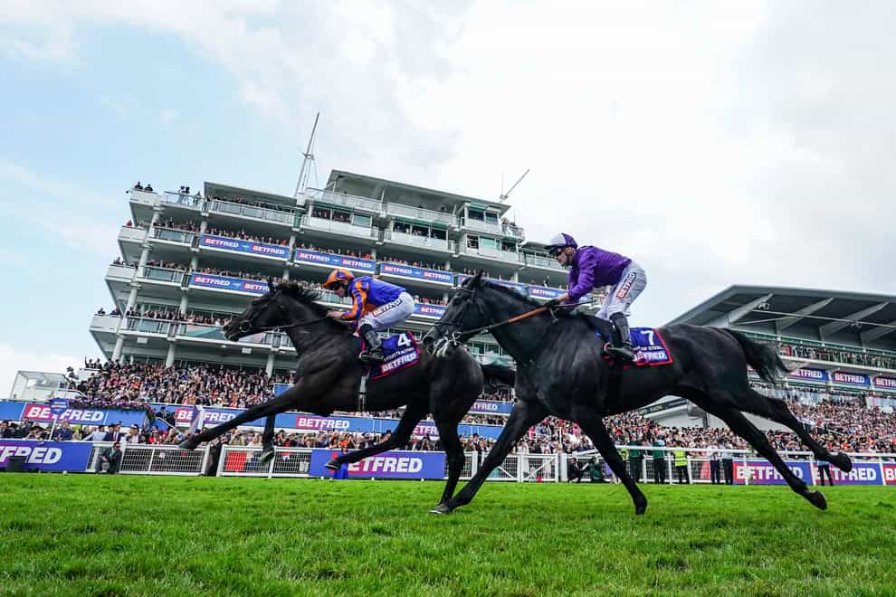 Auguste Rodin ridden by Ryan Moore (left) wins the Betfred Derby (David Davies for the Jockey Club/PA)