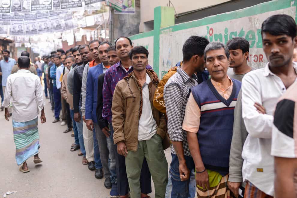 Voters line up outside a polling station in Dhaka, Bangladesh (Mahmud Hossain Opu/AP)