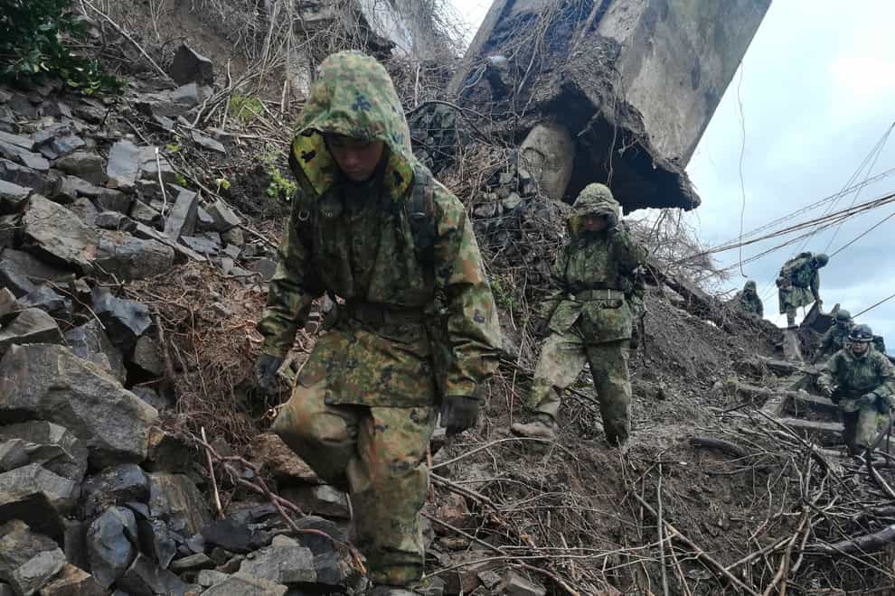 Members of the Japan Self-Defence Forces carry relief goods to an isolated area in Wajima, Ishikawa prefecture (Japanese Ministry of Defence/AP)