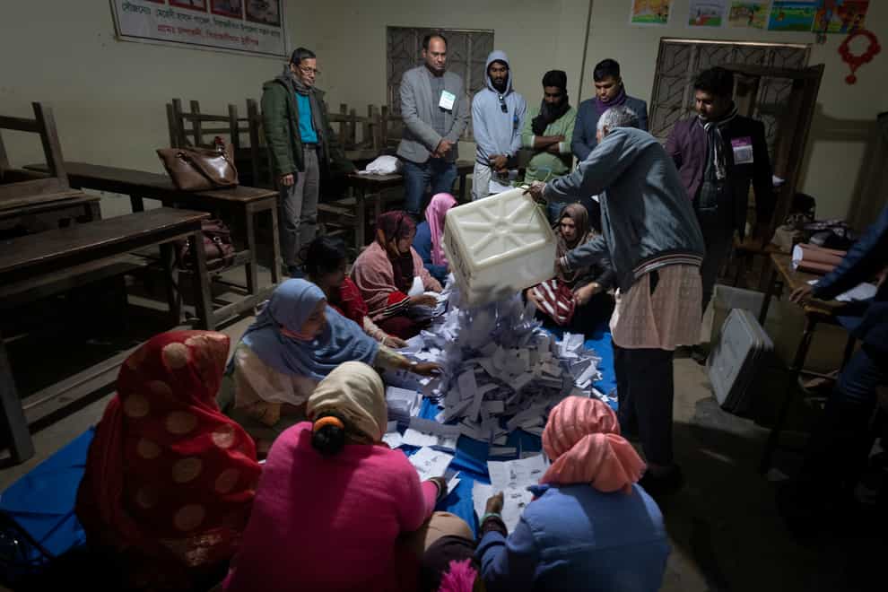 Bangladeshi polling officials empty the ballot boxes (Altaf Qadri/AP)