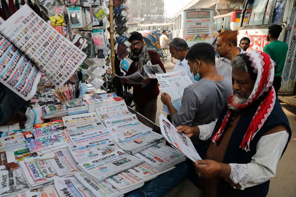 People read Bangladeshi newspapers (AP)