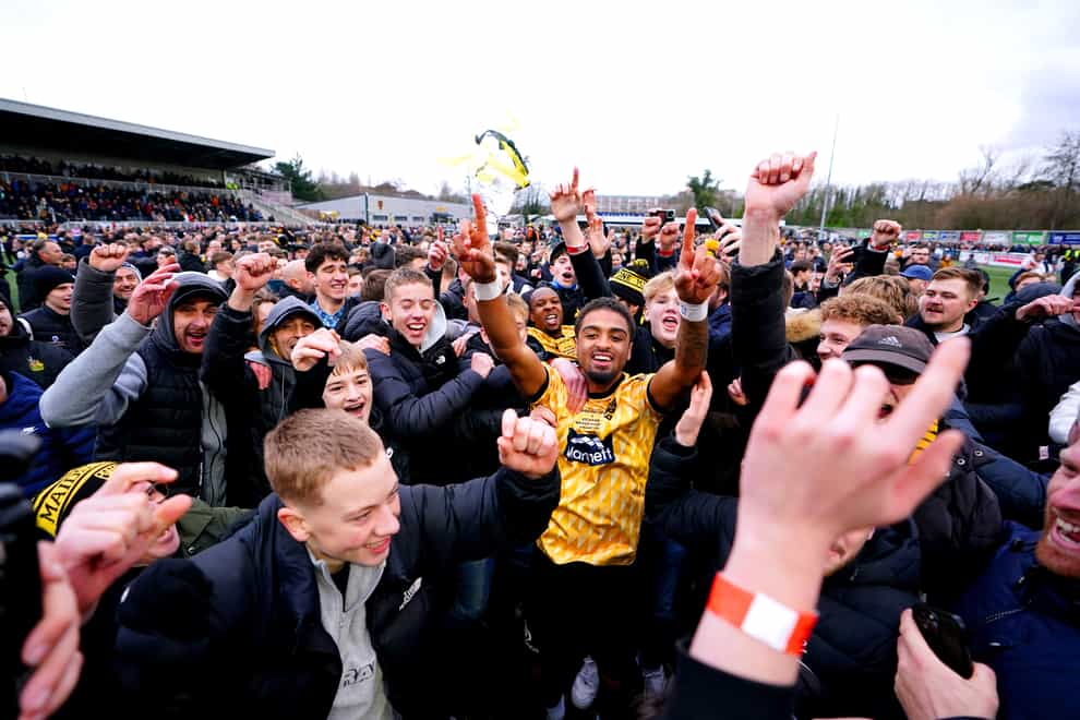 Maidstone’s Liam Sole is mobbed by jubilant fans after Saturday’s win against Stevenage (Zac Goodwin/PA)