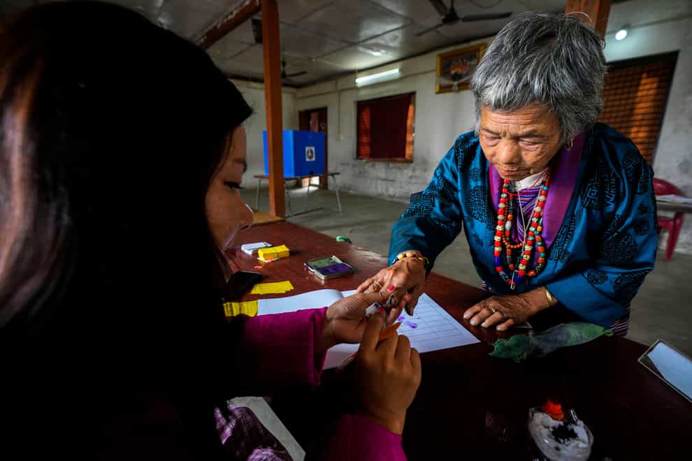 A polling officer puts the indelible ink mark on the finger of a Bhutanese woman in Rikhey village, Bhutan on Tuesday (Anupam Nath/AP)