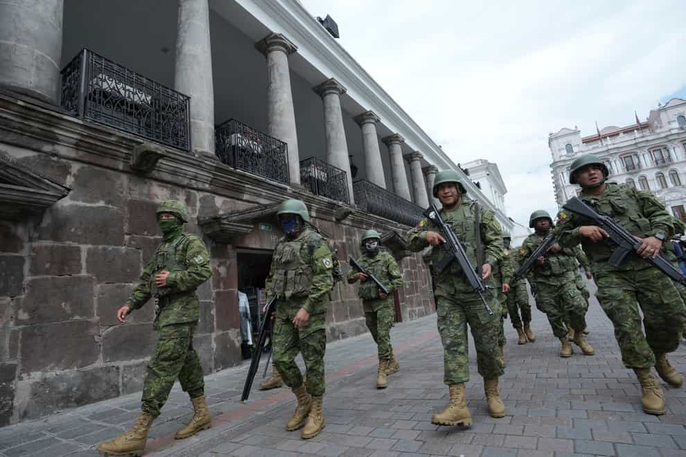 Soldiers patrol outside the government palace during a state of emergency in Quito, Ecuador (Dolores Ochoa/AP)