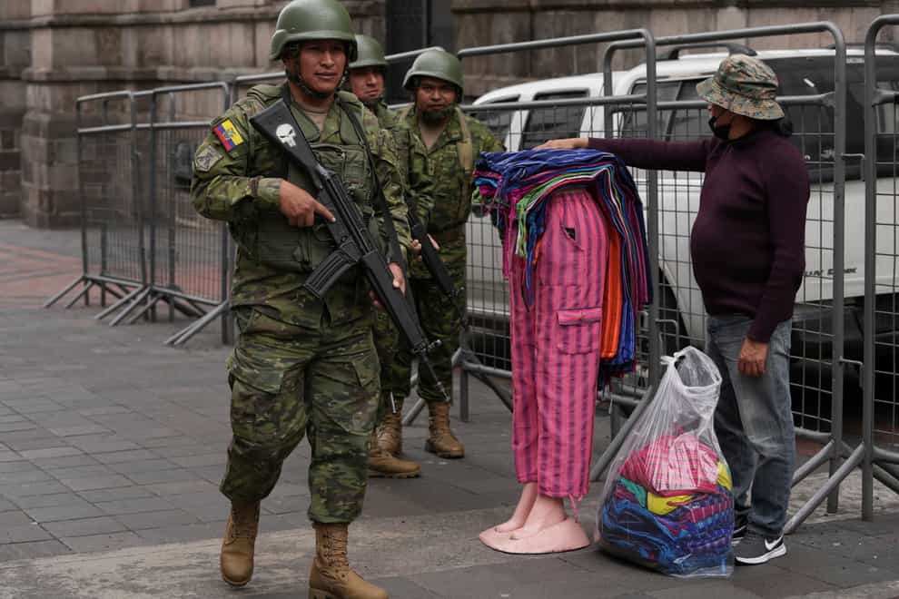 Soldiers patrol outside the government palace during a state of emergency in Quito (Dolores Ochoa/AP)