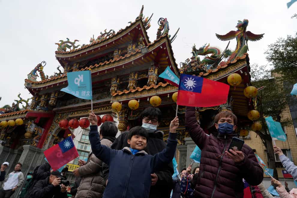 Supporters of Ko Wen-je, Taiwan People’s Party (TPP) presidential candidate, wait for his arrival at a temple in New Taipei City, Taiwan (Ng Han Guan/AP)