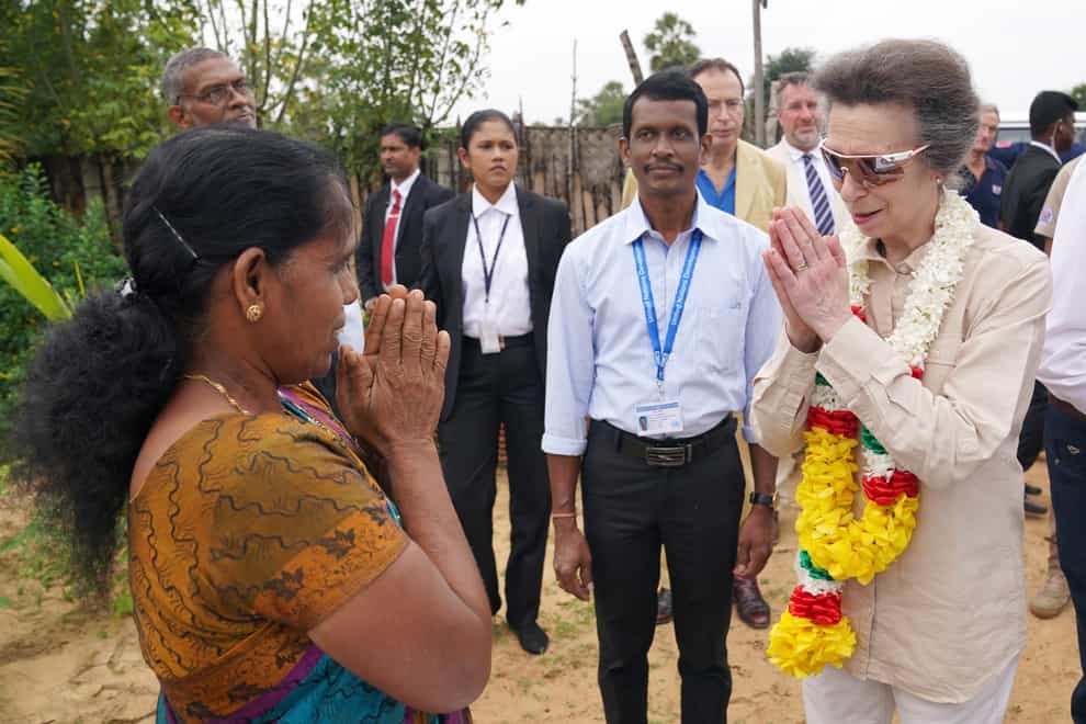 The Princess Royal receives a greeting and a garland of lotus flowers as she visits a resettlement village at the Halo Trust site in Muhamalai during day two of her visit to mark 75 years of diplomatic relations between the UK and Sri Lanka (Jonathan Brady/PA)