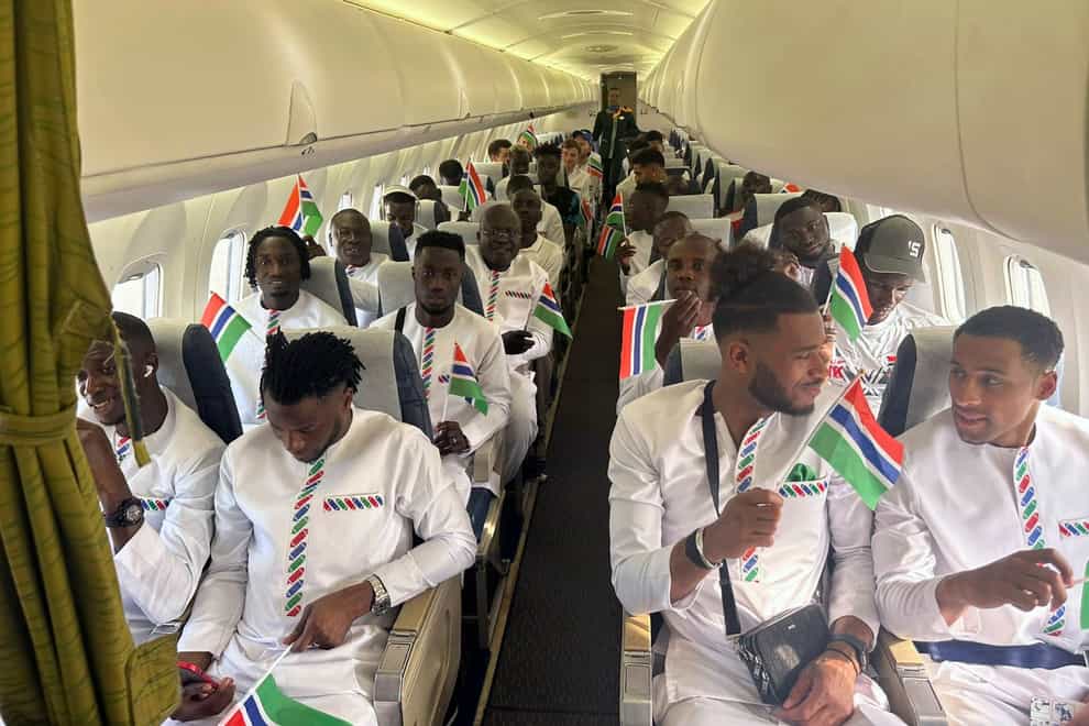 The Gambia national football team aboard a plane in Banjul, Gambia (Gambia Football Federation via AP)