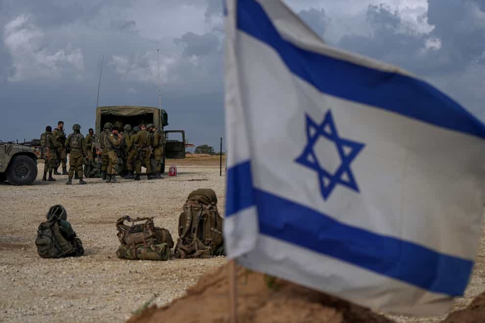 Israeli soldiers are seen near the Gaza Strip border (Tsafrir Abayov/AP)