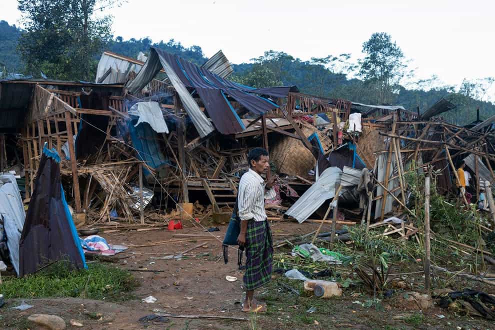 A man looks at homes destroyed after air and artillery strikes in Mung Lai Hkyet displacement camp, in Laiza, Myanmar, in October (AP)