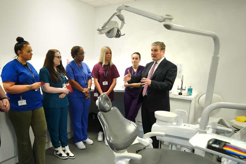 Labour leader Sir Keir Starmer (right) speaks to dental students and staff during a visit to Bury college in Lancashire, to see first-hand the learning facilities being used to train the dental nurses of the future (Peter Byrne/PA)