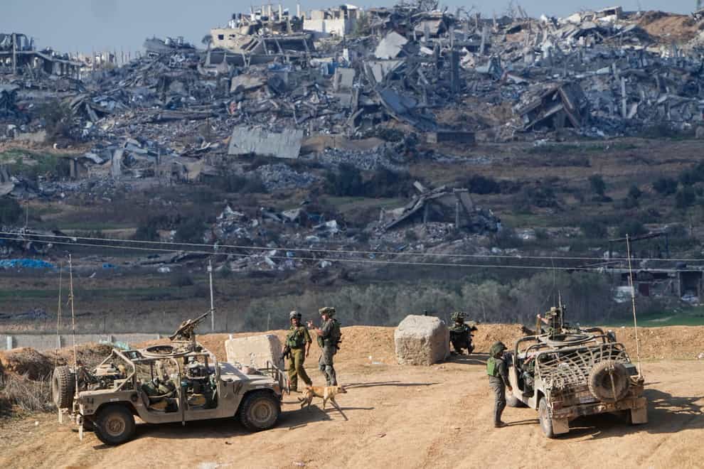 Israeli soldiers take up positions near the Gaza Strip border (Ariel Schalit/AP/PA)