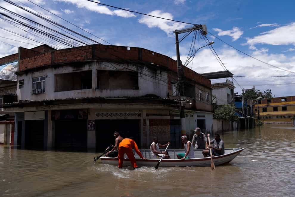Neighbourhoods in Brazil’s Rio de Janeiro state remained flooded on Monday, more than a day after torrential rain killed at least 12 people (Bruna Prado/AP)