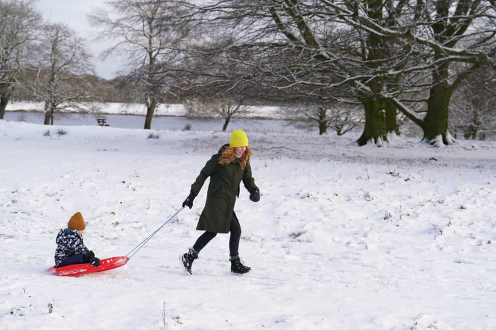 Liz and son Henry sledging on the snow in Tatton Park, Knutsford, Cheshire as the Met Office warns temperatures could plummet as low as minus 15C in the UK (Martin Rickett/PA)