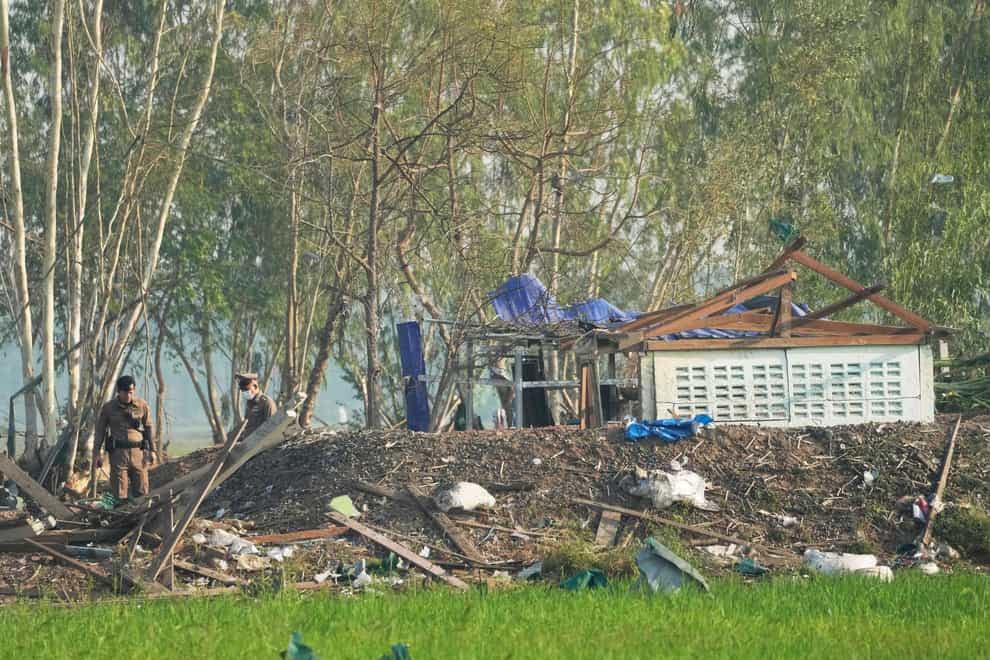 Thai police officers inspect the site of an explosion at a fireworks factory in Suphan Buri province, Thailand (Sakchai Lalit/AP)