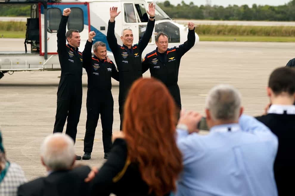 Axiom-3 mission astronauts, from left, mission specialist Marcus Wandt, of Sweden, mission specialist Alper Gezeravci, of Turkey, pilot Walter Villadei, of Italy, and Commander Michael Lopez-Alegria wave to family after arriving at the Kennedy Space Centre in Cape Canaveral, Florida (John Raoux/AP)