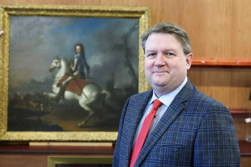 Bloomfield Auctions’ managing director Karl Bennett with a 17th century portrait of King William III that will go under the hammer next week (PressEye/PA)