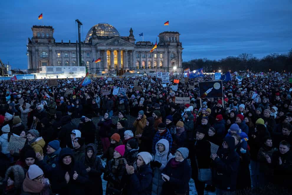 People gathered to protest against the AfD party and right-wing extremism in front of the Reichstag building in Berlin (AP)