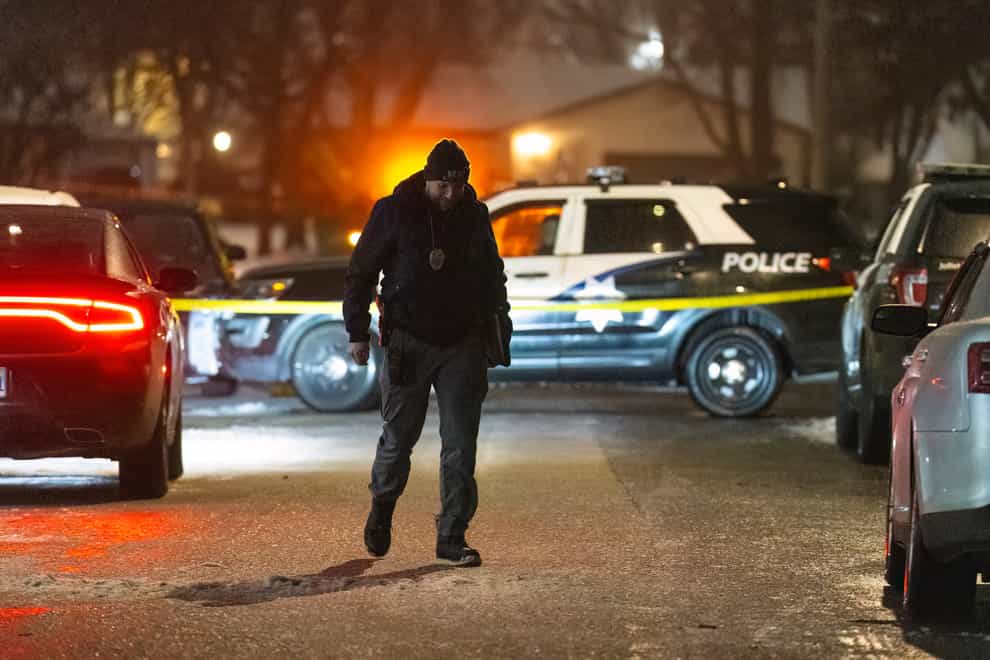 Police work a scene in Joliet, Illinois after multiple people were shot and killed over two days at three locations in the Chicago suburbs (Tyler Pasciak LaRiviere/Chicago Sun-Times via AP)