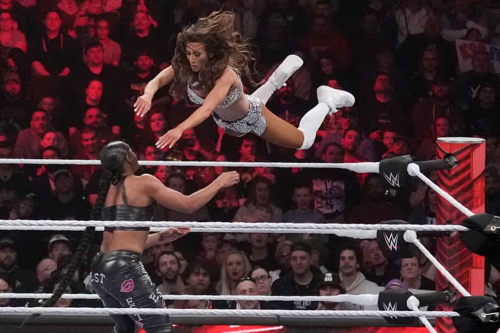 Wrestler Carmella leaps at Bianca Belair during the WWE Monday Night Raw event in March 2023 (Charles Krupa/AP)